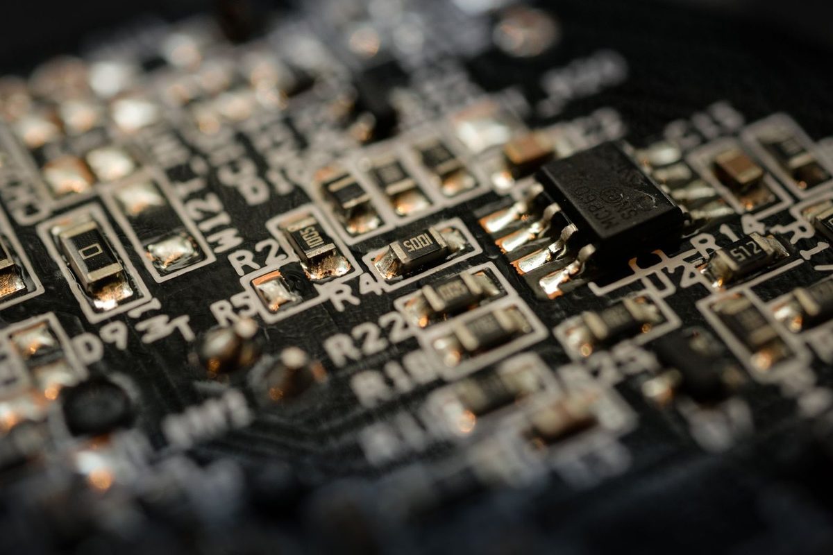 Close-up of a microchip and electronic components on a black circuit board